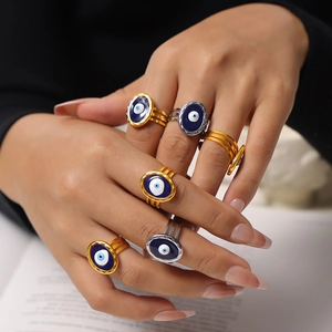 Set of 6 gold and silver titanium steel rings featuring blue evil eye enamel designs