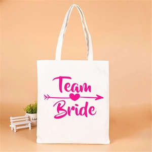 Off-white canvas Team Bride tote bag with pink lettering for bachelorette party favors