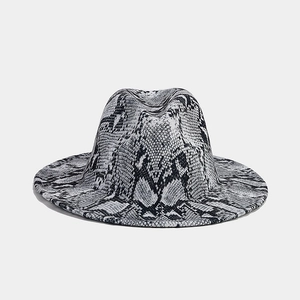 Close-up of black and white snake print pattern on a wide brim fedora hat detail