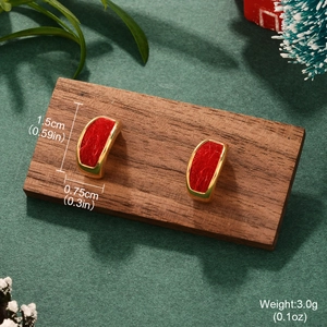 Macro detail of wine red festive earrings with gold metal accents and size dimensions