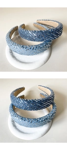 Close-up of knotted denim headbands with sparkling silver sequins in light and dark blue