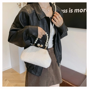 Elegant white faux fur bag featuring pearl strap and vintage metal clasp close-up
