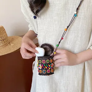 Handmade bohemian coconut shell pouch showing earphone case storage and bead details