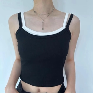 Layered silver bead tassel necklace styled with a black ribbed knit tank top on a model