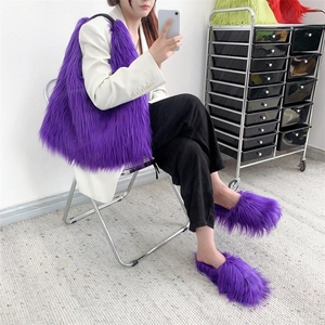 Lifestyle view of purple fuzzy tote bag and matching plush slippers on a model