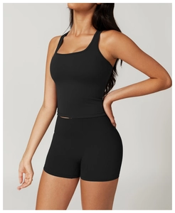 Close-up of black seamless two-piece yoga set with high-waist shorts and racerback tank