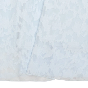 Detailed close-up of light blue evening dress fabric featuring a unique floral jacquard texture