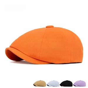 Orange newsboy cap in British retro style made of cotton twill with top button detail