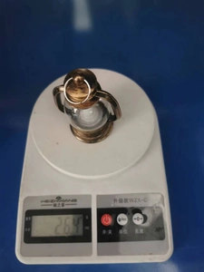 Macro shot showing the lightweight 26.4g vintage bronze lantern on a digital scale