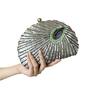 Elegant beaded clutch with silver sequins and peacock feather pattern for evening events