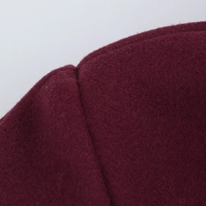 Macro shot of dark red wool blend fabric with soft texture and precision stitching