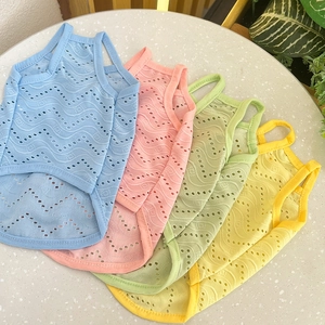 Flat lay of breathable mesh pet vests in pastel blue, pink, green, and yellow