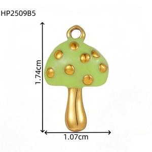 Detail view of gold mushroom pendant in green enamel with dimensions 1.74cm by 1.07cm