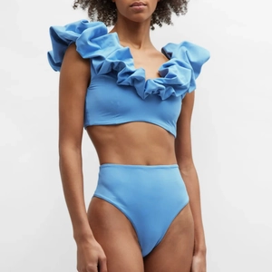 Detailed close-up of sky blue high-waisted bikini with elegant layered ruffle bubble shoulders