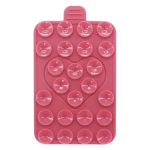Detail of pink silicone suction cup phone holder with double-sided heart design