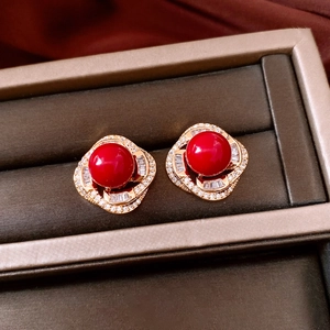 Macro shot of French vintage pearl earrings with red stones and zircon in a jewelry box