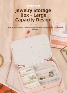 Pink PU leather jewelry box detail showing earring board and ring slots with metal snap