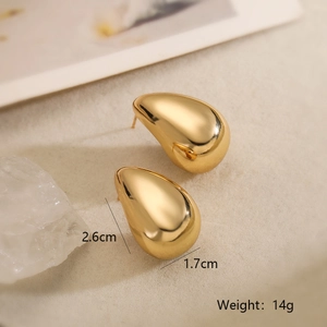 Detail view of gold drop earrings with dimensions 2.6cm by 1.7cm and polished finish