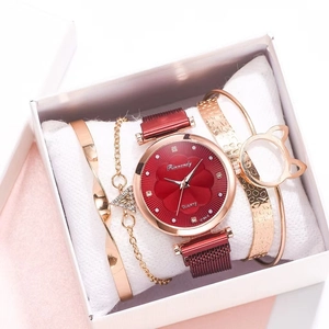 Close-up of a red flower dial watch with gold bracelets set in a white gift box