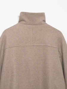 Detailed view of camel wool bomber jacket collar and shoulder stitching texture