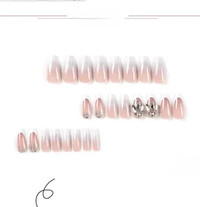 Detail of 24pcs nude pink press on nails with French tips, silver glitter, and rhinestones