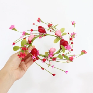 Pink and red heart candle ring wreath with berries and flowers for Valentine table decor