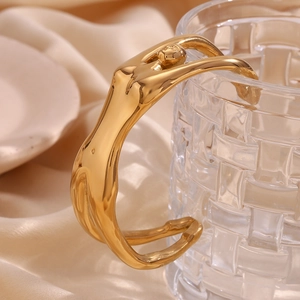 Artistic female body gold plated stainless steel open bangle with a mirror polished finish
