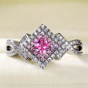 Macro shot of princess cut pink zircon ring with infinity intertwined silver band