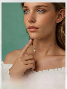 Detailed close-up of a white rose pendant on a 925 silver chain worn by a model