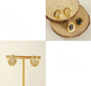 Vue détaillée de boucles d'oreilles dorées avec bordure texturée et pierre œil-de-chat