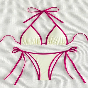 Close-up of beige and pink contrast bikini set with textured fabric on white background