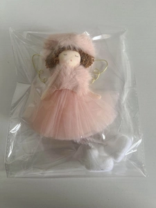Detailed view of pink plush angel doll with golden wings in clear plastic packaging