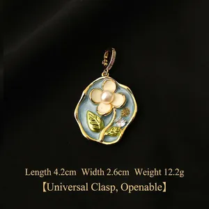 Detail of vintage enamel floral pendant with baroque pearl and functional golden clasp