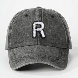 Detailed view of towel embroidered R letter on washed charcoal grey cotton baseball cap