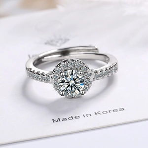 Adjustable silver halo ring with a brilliant round cubic zirconia and side stones
