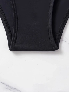 Macro view of high-elastic black swimwear fabric with flat double-needle stitching detail