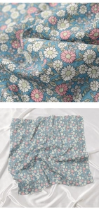 Macro shot of blue floral cotton linen scarf showing fabric texture and daisy pattern