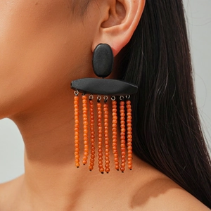 Ethnic bohemian drop earrings with black geometric top and orange beaded tassels