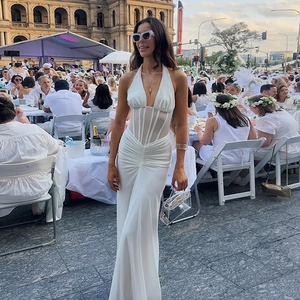 Elegant white halter neck evening dress with ruched details and sheer mesh corset waist