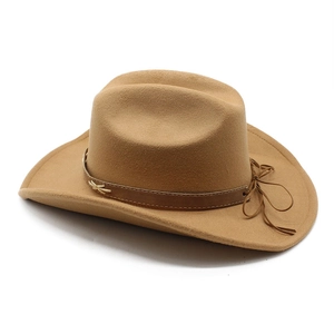 Close-up of khaki wool felt cowboy hat featuring leather band and metal butterfly accent