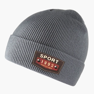 Grey knit beanie featuring a ribbed texture and Sport 1993 leather patch decoration