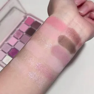 12-color eyeshadow palette with swatches in pink, purple, and shimmer finishes on skin