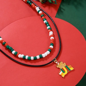 Close-up of double-layer beaded Christmas necklace with a cute bear pendant and gift box