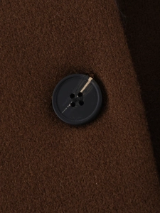 Detailed macro view of the brown wool fabric and marbled four-hole resin button
