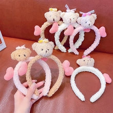 Close-up of cute plush bear headbands in white, beige and pink for girls