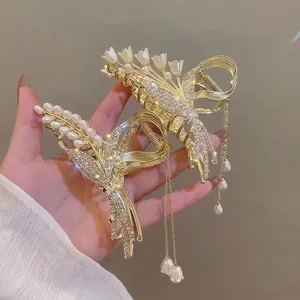 Gouden lelietje-van-dalen haarklem met kwastjes, strasstenen en parels voor dames