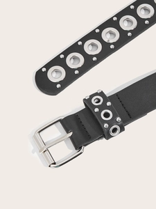 Close-up of punk style black leather belt with silver metal buckle and metal eyelets