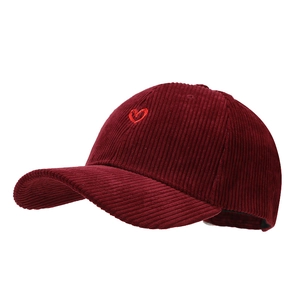 Classic burgundy corduroy baseball cap with red heart embroidery on white background