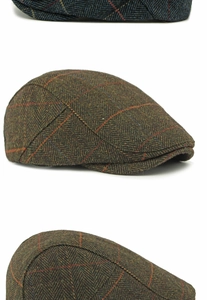 Close-up of herringbone tweed fabric and red windowpane pattern on a wool flat cap