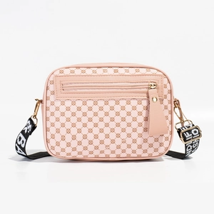 Pink quilted camera crossbody bag with geometric pattern and striped fabric strap